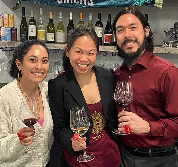 3 people with wine glasses at vinya