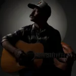 Adam Jones with microphone dim