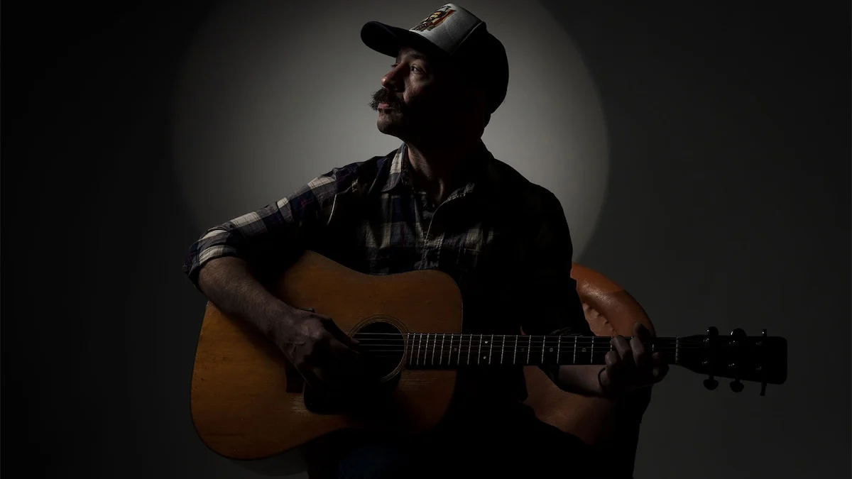 Adam Jones with microphone dim