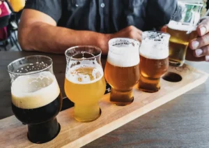 Closeup photo beer glasses wooden tasting board