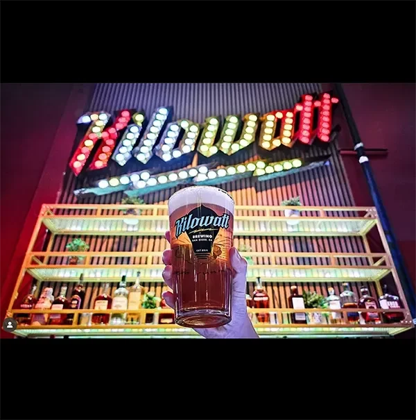 Kilowatt brewig beer glass raised