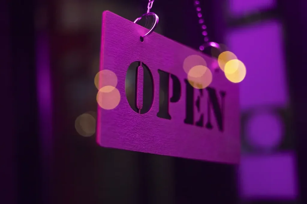Open Sign Hanging With Purple Light Copy