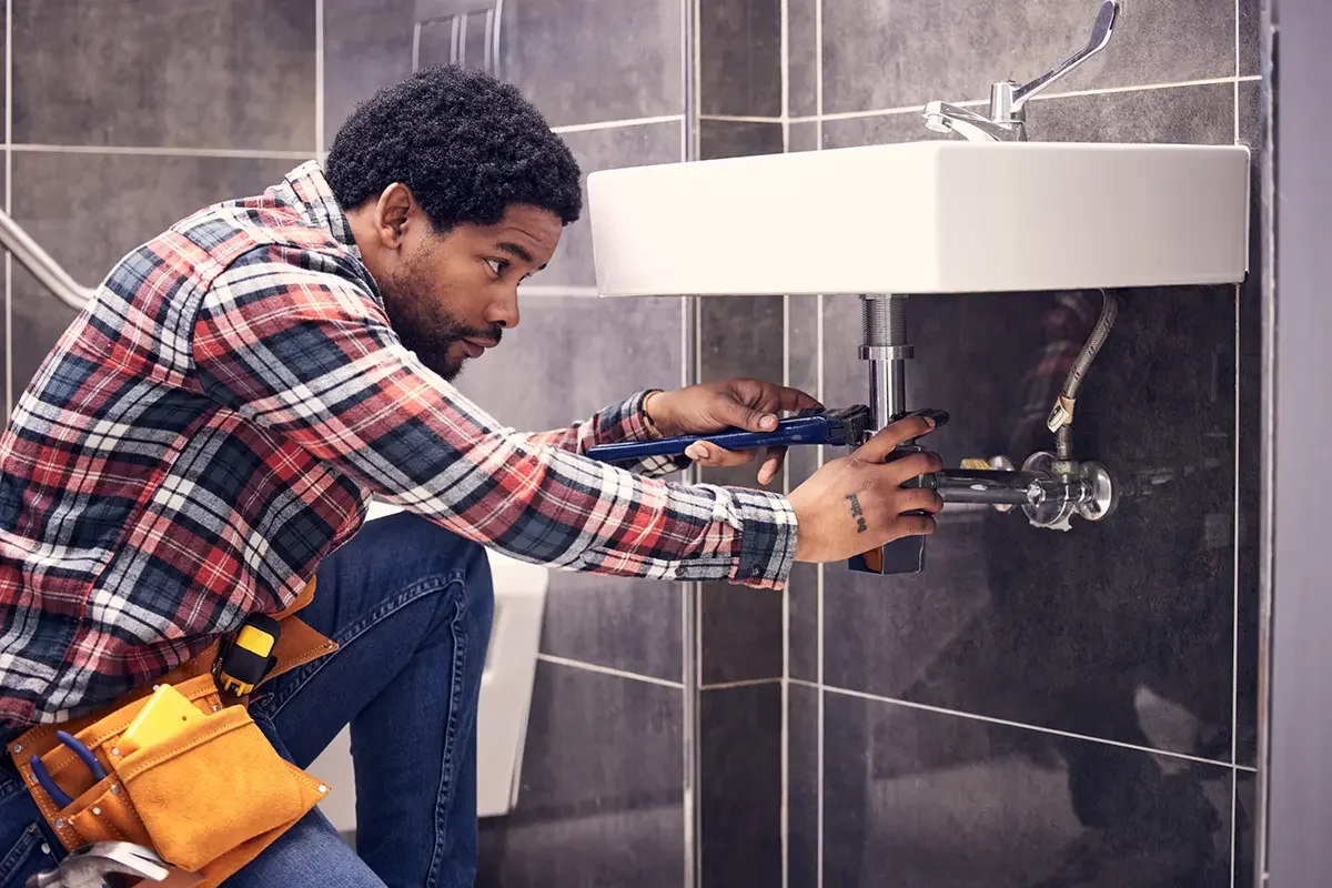 Plumber fixing sink