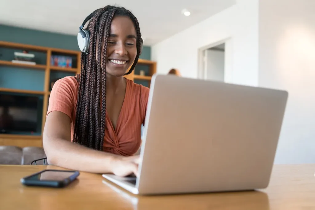 Woman with headphones on laptop